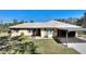 House with carport and well-maintained lawn at 4680 Poinciana Dr, Indian Lake Estates, FL 33855