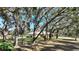 Ranch-style home nestled amongst mature oak trees in spacious yard at 4680 Poinciana Dr, Indian Lake Estates, FL 33855