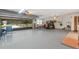 Spacious garage with an open door and a golf cart inside at 4680 Poinciana Dr, Indian Lake Estates, FL 33855