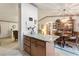 Kitchen with granite island, wood cabinets, and dining area view at 4680 Poinciana Dr, Indian Lake Estates, FL 33855