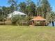 Lakefront property with a gazebo and dock at 4680 Poinciana Dr, Indian Lake Estates, FL 33855