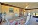 Bright screened porch with table and chairs, perfect for relaxing at 4680 Poinciana Dr, Indian Lake Estates, FL 33855