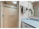 Bathroom with a shower and granite countertop vanity with towels hanging on the wall at 4680 Poinciana Dr, Indian Lake Estates, FL 33855
