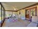 Inviting sunroom features tile flooring, ceiling fan, neutral color palette, and an entrance to the main house at 4680 Poinciana Dr, Indian Lake Estates, FL 33855