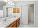 Bathroom featuring a double vanity with wood cabinets and a sliding door to a closet at 515 Torres Pl, Lady Lake, FL 32159