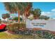Community pool signage surrounded by landscaping and palm trees with ample parking at 515 Torres Pl, Lady Lake, FL 32159