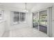 Bright dining area features tile flooring, a window with blinds, and access to an enclosed patio at 515 Torres Pl, Lady Lake, FL 32159