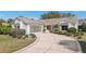 Welcoming home with well-maintained lawn and a spacious driveway leading to a two-car garage at 515 Torres Pl, Lady Lake, FL 32159