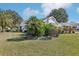 Beautiful home with lush landscaping, palm trees, and a well-manicured lawn at 515 Torres Pl, Lady Lake, FL 32159