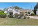 Charming single-story home featuring manicured landscaping and classic architectural details at 515 Torres Pl, Lady Lake, FL 32159