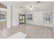 Bright living room with tile flooring, neutral walls, and a sliding glass door to the backyard at 515 Torres Pl, Lady Lake, FL 32159