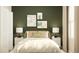Bedroom with green accent wall, white bedding, and nightstands at 7310 Ivy Tendril Ave, Orlando, FL 32829