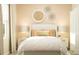 Bedroom with white bedding, nightstands, and wall decor at 7310 Ivy Tendril Ave, Orlando, FL 32829