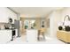 Open concept kitchen with white cabinets, island, and stainless steel appliances at 7310 Ivy Tendril Ave, Orlando, FL 32829