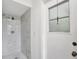 Clean bathroom with a large marble shower and small window at 10420 Vista Del Sol Cir, Clermont, FL 34711