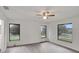 Spacious bedroom with gray vinyl flooring and three large windows at 10420 Vista Del Sol Cir, Clermont, FL 34711