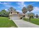 Two-story house with a two-car garage and palm trees at 10420 Vista Del Sol Cir, Clermont, FL 34711