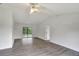 Open living room with gray vinyl flooring and sliding glass doors at 10420 Vista Del Sol Cir, Clermont, FL 34711