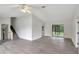 Bright living room with gray vinyl flooring and sliding glass doors at 10420 Vista Del Sol Cir, Clermont, FL 34711