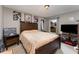 Well-lit bedroom with a double bed and wood furniture at 1504 Fort Meade Pl, Poinciana, FL 34759