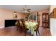 Dining room with a wooden table, banana-themed tablecloth, and hardwood floors at 1504 Fort Meade Pl, Poinciana, FL 34759