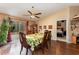 Dining area with wooden table and chairs, offering access to a bedroom and kitchen at 1504 Fort Meade Pl, Poinciana, FL 34759