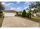 House with a white garage door and neatly landscaped front yard at 1504 Fort Meade Pl, Poinciana, FL 34759