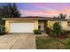 House exterior at sunset with landscaping at 1504 Fort Meade Pl, Poinciana, FL 34759