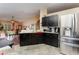 Spacious kitchen with granite countertops and dark wood cabinets at 1504 Fort Meade Pl, Poinciana, FL 34759