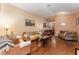 Living room featuring hardwood floors, comfy couches, and large windows at 1504 Fort Meade Pl, Poinciana, FL 34759