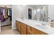 Bathroom with double vanity, large mirror, and walk-in shower at 20 Hemlock Trl, Ocala, FL 34472