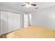 Main bedroom with ceiling fan, double door closet and plush carpeting at 20 Hemlock Trl, Ocala, FL 34472