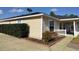 Side view of a one-story house with well-maintained landscaping at 20 Hemlock Trl, Ocala, FL 34472