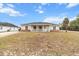 One-story house with front porch, light beige siding, and a yard at 20 Hemlock Trl, Ocala, FL 34472