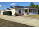 One-story home with covered porch, landscaped yard, and driveway at 20 Hemlock Trl, Ocala, FL 34472