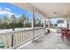 Front porch with white railing, red chairs, and view of street at 20 Hemlock Trl, Ocala, FL 34472