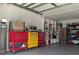 Garage with lots of storage including shelving and rolling tool boxes at 20 Hemlock Trl, Ocala, FL 34472