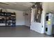 Garage includes water heater, HVAC unit, and metal shelving at 20 Hemlock Trl, Ocala, FL 34472