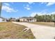 House exterior with driveway and landscaping at 20 Hemlock Trl, Ocala, FL 34472