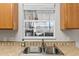 Kitchen sink with tile backsplash and window overlooking backyard at 20 Hemlock Trl, Ocala, FL 34472