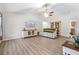 Living room with vaulted ceiling and wood-look floors at 20 Hemlock Trl, Ocala, FL 34472