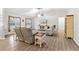 Spacious living room with light brown vinyl flooring, a ceiling fan, and comfortable seating at 20 Hemlock Trl, Ocala, FL 34472