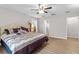 Main bedroom with king-size bed, ensuite bathroom access, and ceiling fan at 20 Hemlock Trl, Ocala, FL 34472