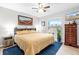 King-size bed in a spacious bedroom with a ceiling fan at 20 Hemlock Trl, Ocala, FL 34472