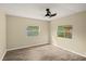 Bright bedroom with two windows and ceiling fan at 2519 State Park Rd, Lakeland, FL 33805