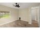 Charming bedroom with wood-look floors and a window overlooking trees at 2519 State Park Rd, Lakeland, FL 33805