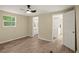 Well-lit bedroom with wood-look floors and access to bathroom at 2519 State Park Rd, Lakeland, FL 33805