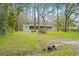 Gray mobile home with screened porch and large yard at 2519 State Park Rd, Lakeland, FL 33805