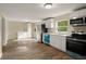 Modern kitchen with white cabinets, stainless steel appliances, and wood-look floors at 2519 State Park Rd, Lakeland, FL 33805