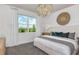 Main bedroom with large window, a king-size bed, and a neutral color scheme at 6805 Sw 90Th Loop, Ocala, FL 34476